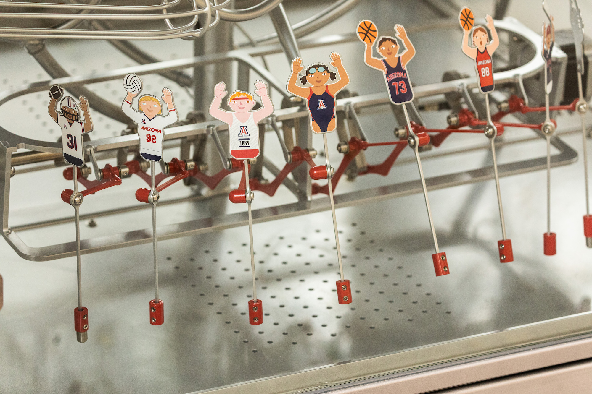 sculptures of athletes inside the machine