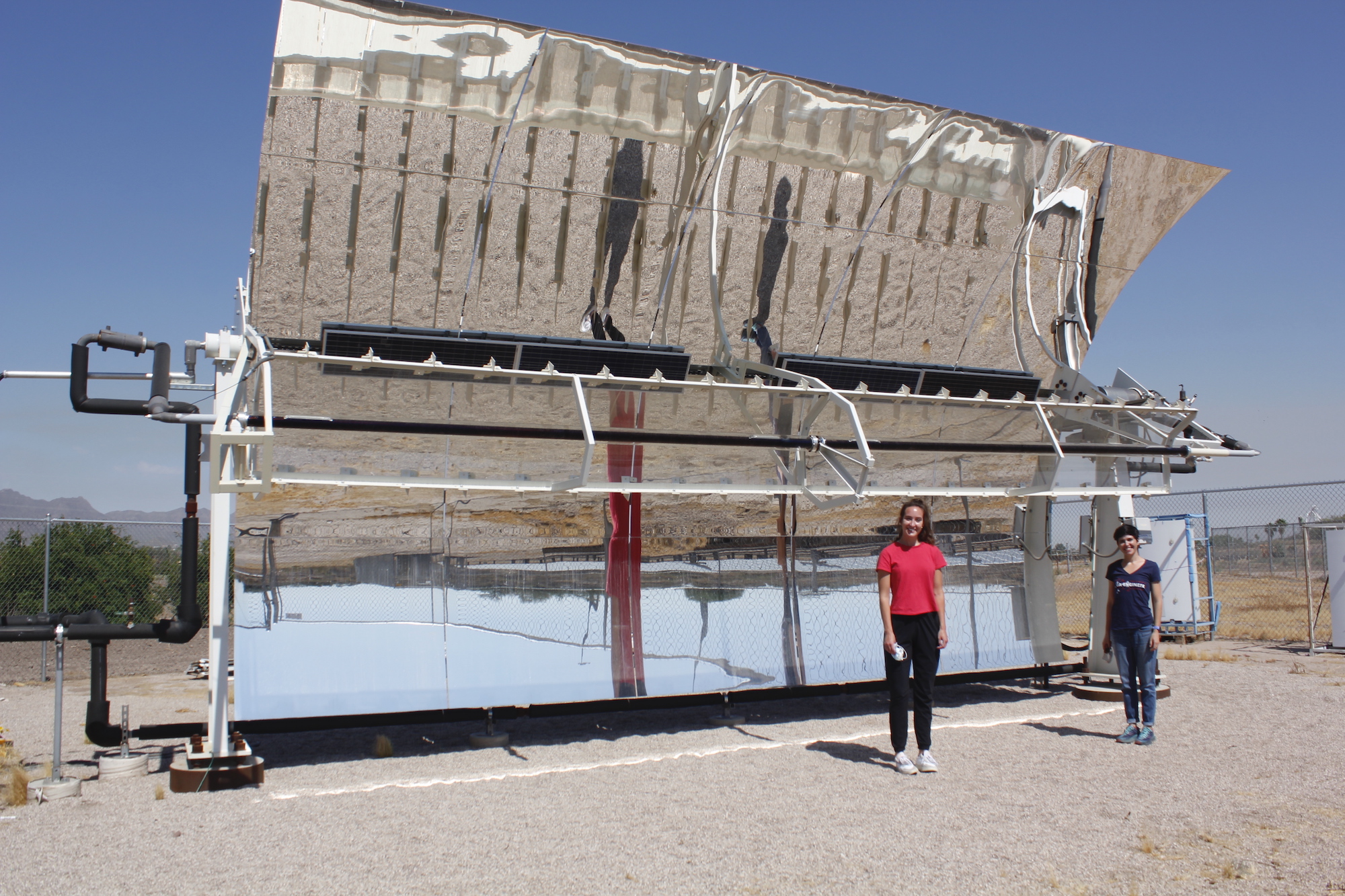 Kerri Hickenbottom and Mikah Inkawhich in front of a solar-powered desalination system