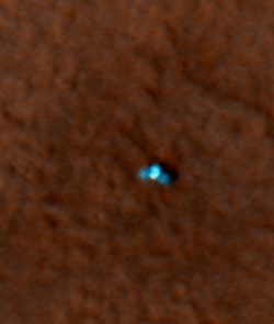 This shows a color image from Mars Reconnaissance Orbiter's High Resolution Imaging Science Experiment (HiRISE) camera. It shows the Phoenix lander with its solar panels deployed on the Mars surface. The Phoenix Mission is led by the University of Arizona, Tucson, on behalf of NASA. Project management of the mission is by NASA's Jet Propulsion Laboratory, Pasadena, Calif. Spacecraft development is by Lockheed Martin Space Systems, Denver. (Image by: NASA/JPL-Caltech/University of Arizona) This shows a color image from Mars Reconnaissance Orbiter's High Resolution Imaging Science Experiment (HiRISE) camera. It shows the Phoenix lander with its solar panels deployed on the Mars surface. The Phoenix Mission is led by the University of Arizona, Tucson, on behalf of NASA. Project management of the mission is by NASA's Jet Propulsion Laboratory, Pasadena, Calif. Spacecraft development is by Lockheed Martin Space Systems, Denver. (Image by: NASA/JPL-Caltech/University of Arizona)