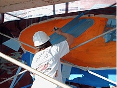 UA senior art student Bonnie Streff paints the Phoenix Mars Lander that is part of the mural on the mission's Science Operations Center in Tucson. (Photo: Angela Poulson) UA senior art student Bonnie Streff paints the Phoenix Mars Lander that is part of the mural on the mission's Science Operations Center in Tucson. (Photo: Angela Poulson)