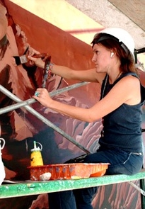 UA senior Cassidy Reis adds paint to part of the mural that has transformed the south exterior wall of the Phoenix Mars Mission Science Operations Center in Tucson. (Photo: Angela Poulson) UA senior Cassidy Reis adds paint to part of the mural that has transformed the south exterior wall of the Phoenix Mars Mission Science Operations Center in Tucson. (Photo: Angela Poulson)