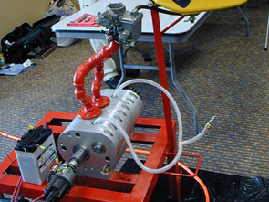 A team of mechanical engineering seniors designed and built this prototype engine in only eight months on a shoestring budget. The students received valuable support from Raytheon, the University Research Instrumentation Center and UA's Aerospace and Mechanical Engineering Department. (Photo by Susie Bowers) A team of mechanical engineering seniors designed and built this prototype engine in only eight months on a shoestring budget. The students received valuable support from Raytheon, the University Research Instrumentation Center and UA's Aerospace and Mechanical Engineering Department. (Photo by Susie Bowers)
