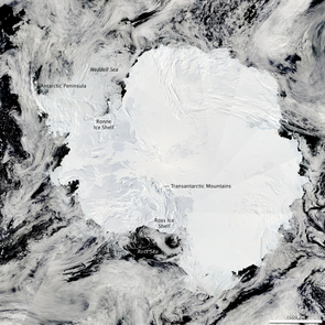 The Moderate Resolution Imaging Spectroradiometer on NASA’s Aqua satellite captured this composite image of Antarctica’s ice-covered landscape on Jan. 27, 2009. The surface appears rough where the Transantarctic Mountains curve in a shallow “s” from the shore of the Ross Sea to the Ronne Ice Shelf. The Polar Plateau in the center of the continent is smooth, shaded only by the faint shadow cast by clouds. The Weddell Sea is textured with chunks of sea ice. (Photo Credit: NASA image courtesy the MODIS Rapid Response Team at NASA GSFC) The Moderate Resolution Imaging Spectroradiometer on NASA’s Aqua satellite captured this composite image of Antarctica’s ice-covered landscape on Jan. 27, 2009. The surface appears rough where the Transantarctic Mountains curve in a shallow “s” from the shore of the Ross Sea to the Ronne Ice Shelf. The Polar Plateau in the center of the continent is smooth, shaded only by the faint shadow cast by clouds. The Weddell Sea is textured with chunks of sea ice. (Photo Credit: NASA image courtesy the MODIS Rapid Response Team at NASA GSFC)