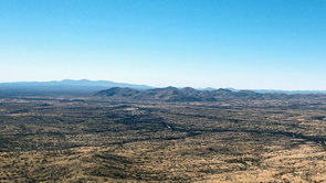 When viewed from the top of a mountain in the Buenos Aires National Wildlife Refuge, the border wall becomes a thin black line that is almost invisible against the seamless landscape of the Sonoran Desert. "Ecologically, the border does not exist," Benjamin Wilder says. (Photo: Emily Walla/UANews) When viewed from the top of a mountain in the Buenos Aires National Wildlife Refuge, the border wall becomes a thin black line that is almost invisible against the seamless landscape of the Sonoran Desert. "Ecologically, the border does not exist," Benjamin Wilder says. (Photo: Emily Walla/UANews)
