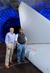 Israel Wygnanski (left), professor of aerospace and mechanical engineering, and Caltech collaborator Emilio Graff introduced and developed the active flow control system tested recently on this Boeing 757 vertical tail in the wind tunnel at NASA's Ames Research Center. (Photo courtesy of NASA Ames Research Center)