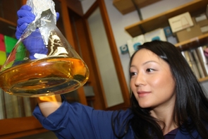 Graduate student and study lead author Eun-Hae Kim checks on a flask containing bacteria growing in a liquid medium. (Photo by Beatriz Verdugo/UANews) Graduate student and study lead author Eun-Hae Kim checks on a flask containing bacteria growing in a liquid medium. (Photo by Beatriz Verdugo/UANews)
