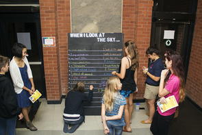 Katy Galaz, second from right, hosts a group of attendees at the "Interactive Chalkboard Intervention." (Photo: Mallory Shibe) Katy Galaz, second from right, hosts a group of attendees at the "Interactive Chalkboard Intervention." (Photo: Mallory Shibe)