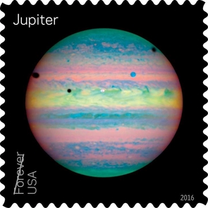 NASA’s Hubble Space Telescope has obtained many beautiful images of Jupiter, including the unusual one that is featured on the stamp pane. Hubble’s Near Infrared Camera and Multi-Object Spectrometer captured this view in 2004 during a rare alignment of three of the planet’s moons: Io, Ganymede, and Callisto. The three dark circles in the image are the shadows cast by those moons. Viewing Jupiter in the near infrared makes the planet appear to be pastel colored while its clouds show different colors depending on their altitude. (Image: NASA/ESA/Erich Karkoschka)
NASA’s Hubble Space Telescope has obtained many beautiful images of Jupiter, including the unusual one that is featured on the stamp pane. Hubble’s Near Infrared Camera and Multi-Object Spectrometer captured this view in 2004 during a rare alignment of three of the planet’s moons: Io, Ganymede, and Callisto. (Image: NASA/ESA/Erich Karkoschka)