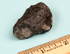 Exterior of a meteorite produced when a small asteroid broke up in the atmosphere near Novato, California, on Oct. 17, 2012. It shows extensive dark impact melt. Classified as an ordinary chondrite, the Novato meteorite came from a different asteroid than the Chelyabinsk bolide, but both experienced major impacts at about the same time as the moon-forming giant impact. (Photo: Peter Jenniskens, SETI Institute) Exterior of a meteorite produced when a small asteroid broke up in the atmosphere near Novato, California, on Oct. 17, 2012. It shows extensive dark impact melt. Classified as an ordinary chondrite, the Novato meteorite came from a different asteroid than the Chelyabinsk bolide, but both experienced major impacts at about the same time as the moon-forming giant impact. (Photo: Peter Jenniskens, SETI Institute)