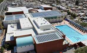 (Click image to enlarge) The Solar Thermal Array installed on top of the UA’s recreation center (in the background) has an estimated annual production equivalent of almost 2 million kilowatt-hours and is expected to reduce greenhouse gas emissions by 1,317 metric tons per year. It is the latest addition in a portfolio of innovations promoting energy efficiency and sustainability on the UA campus. (Photo: Ameresco Southwest) (Click image to enlarge) The Solar Thermal Array installed on top of the UA’s recreation center (in the background) has an estimated annual production equivalent of almost 2 million kilowatt-hours and is expected to reduce greenhouse gas emissions by 1,317 metric tons per year. It is the latest addition in a portfolio of innovations promoting energy efficiency and sustainability on the UA campus. (Photo: Ameresco Southwest)