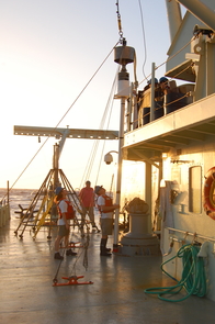 A researcher stares up at the 20-foot-long coring device that will be lowered over the side of the R/V Oceanus. The resulting core of marine sediments from off the West African coast will contain sediments laid down over about 40,000 years. (Photo: Peter deMenocal) A researcher stares up at the 20-foot-long coring device that will be lowered over the side of the R/V Oceanus. The resulting core of marine sediments from off the West African coast will contain sediments laid down over about 40,000 years. (Photo: Peter deMenocal)