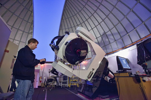 Adam Block adjusts the telescope to point to an object in the evening sky. (Photo: David Harvey) Adam Block adjusts the telescope to point to an object in the evening sky. (Photo: David Harvey)