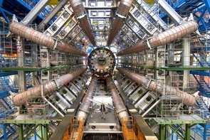 A person stands in front of the huge ATLAS detector, one of six detectors that are part of the Large Hadron Collider near Geneva. A person stands in front of the huge ATLAS detector, one of six detectors that are part of the Large Hadron Collider near Geneva.