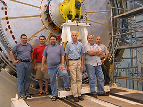 UA physicist John Rutherfoord (center, in the light blue shirt) and colleagues are dwarfed by part of the forward calorimeter, the device the team developed and built for ATLAS. Pictured, from left, are Alexandre Savine of the UA; Phillipe Gravelle from Carleton University in Ottawa; Peter Loch of the UA; Rutherfoord; Leif Shaver of the UA; Mircea Cadabeschi from the University of Toronto. UA physicist John Rutherfoord (center, in the light blue shirt) and colleagues are dwarfed by part of the forward calorimeter, the device the team developed and built for ATLAS. Pictured, from left, are Alexandre Savine of the UA; Phillipe Gravelle from Carleton University in Ottawa; Peter Loch of the UA; Rutherfoord; Leif Shaver of the UA; Mircea Cadabeschi from the University of Toronto.