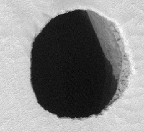 The High Resolution Imaging Experiment (HiRISE) camera operated at The University of Arizona released this new view of the dark pit on Arsia Mons (PSP_004847_1745) today. This view is not the entire HiRISE image, but a close-up of the pit on the Arsia Mons volcano. The new image confirms that the dark pit really is a vertical shaft that cuts through lava flow on the flank of the volcano. Such pits form on similar volcanoes in Hawaii and are called "pit craters." (Credit: NASA/JPL/University of Arizona)
New View of Dark Pit on Arsia Mons