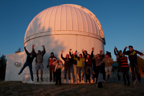 Students from Tucson schools bid farewell to the sun in front of one of the telescope domes at the UA’s Mt. Lemmon SkyCenter. (Photo by Ben Blonder/UA Science: Sky School)