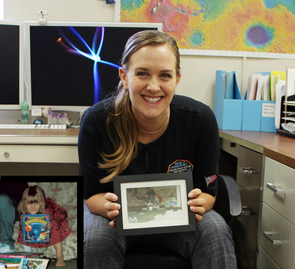 How it all began: Veronica Bray shows a photo of herself when she was 6, holding her "favorite birthday present" – a book about the universe (see inset at lower left). (Photo: Shipherd Reed/UA) How it all began: Veronica Bray shows a photo of herself when she was 6, holding her "favorite birthday present" – a book about the universe (see inset at lower left). (Photo: Shipherd Reed/UA)