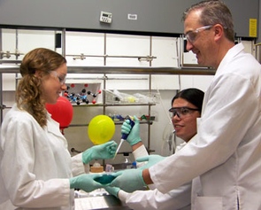 UA associate professor Mark "Marty" Pagel, far right, with chemical engineering student Michelle Benson, left, and University of Arizona Cancer Center student Tony Ward. Pagel's MRI method produces an image that maps the acid content in tissues, which enables doctors to monitor the effectiveness of personalized treatments such as baking soda on tumors and normal tissue, and could even predict the effectiveness of chemotherapies before the patient starts the medication. (UA Biomedical Engineering photo) UA associate professor Mark "Marty" Pagel, far right, with chemical engineering student Michelle Benson, left, and University of Arizona Cancer Center student Tony Ward. Pagel's MRI method produces an image that maps the acid content in tissues, which enables doctors to monitor the effectiveness of personalized treatments such as baking soda on tumors and normal tissue, and could even predict the effectiveness of chemotherapies before the patient starts the medication. (UA Biomedical Engineering photo)
