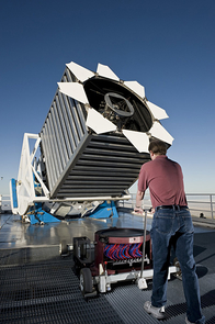 Engineer Dan Long loads the first cartridge of the night into the Sloan Digital Sky Survey telescope. The cartridge holds "plug-plates" at the top, which then hold a thousand optical fibers shown in red and blue. The cartridges are locked into the base of the telescope and changed many times overnight. Engineer Dan Long loads the first cartridge of the night into the Sloan Digital Sky Survey telescope. The cartridge holds "plug-plates" at the top, which then hold a thousand optical fibers shown in red and blue. The cartridges are locked into the base of the telescope and changed many times overnight.