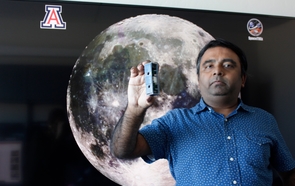 Jekan Thanga holds a FemtoSat developed in the UArizona SpaceTREx Laboratory. (Photo: Emily Dieckman/College of Engineering) Jekan Thanga holds a FemtoSat developed in the UArizona SpaceTREx Laboratory. (Photo: Emily Dieckman/College of Engineering)