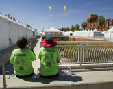 Volunteers take a break amid the dozens of festival tents. Volunteers take a break amid the dozens of festival tents.