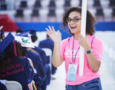 Veronica Cruz-Mercado, UA Bookstores program coordinator, signals while serving as a volunteer during the Commencement ceremony. Veronica Cruz-Mercado, UA Bookstores program coordinator, signals while serving as a volunteer during the Commencement ceremony.