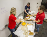 Volunteers loading plates with chorizo, eggs, beans and cheese. (Photo: Kyle Mittan/University Communications)