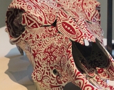 "Carnivore's Gratitude" by Ramona Walls, senior scientific analyst at the BIO5 Institute An animal skull with red outlines painted on it.