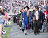 Faculty members process into Arizona Stadium. Faculty members process into Arizona Stadium.