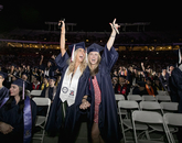 Nikki Malinoff and Amanda Lennon, both graduates of the College of Social and Behavioral Sciences, celebrate in the aisles when their college's dean, John Paul Jones III, calls for graduates to stand and be recognized. Nikki Malinoff and Amanda Lennon, both graduates of the College of Social and Behavioral Sciences, celebrate in the aisles when their college's dean, John Paul Jones III, calls for graduates to stand and be recognized.