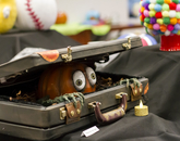 This pumpkin, crafted to appear as if it were eerily crawling out of a suitcase, earned second place in the Office of the Provost's pumpkin-crafting contest. (Photo: Kyle Mittan/University Communications) A decorated pumpkin, with hands and arms, appears to be eerily crawling out of a suitcase.