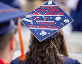 Sarah Rojo, who received a degree in general studies, looks for her family in the stands at Arizona Stadium. Sarah Rojo, who received a degree in general studies, looks for her family in the stands at Arizona Stadium.