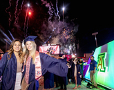Friends Ciara Valencia, who graduated in political science, and Emily James, a public health graduate, are framed by the fireworks display that traditionally concludes the ceremony. (Photo: John de Dios/UA News) Friends Ciara Valencia, who graduated in political science, and Emily James, a public health graduate, are framed by the fireworks display that traditionally concludes the ceremony. (Photo: John de Dios/UA News)