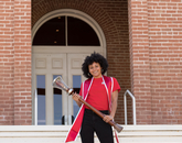 Shelby Young, a senior graduating with degrees in Africana studies and microbiology, poses with the university's ceremonial mace during filming for the virtual 2020 Commencement. (Photo: Chris Richards/University of Arizona) Shelby Young, a senior graduating with degrees in Africana studies and microbiology, poses with the university's ceremonial mace during filming for the virtual 2020 Commencement. (Photo: Chris Richards/University of Arizona)