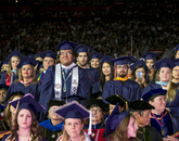 Professional and graduate students rise to be conferred degrees by UA President Robert C. Robbins. (Photo: John de Dios/UANews) Professional and graduate students rise to be conferred degrees by UA President Robert C. Robbins. (Photo: John de Dios/UANews)