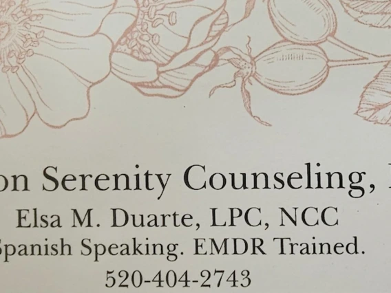 A business card for Tucson Serenity Counseling, LLC, listing Elsa M. Duarte, LPC, NCC. The card notes “Spanish Speaking. EMDR Trained.” and includes a phone number, 520-404-2743. A floral design decorates the top of the card.