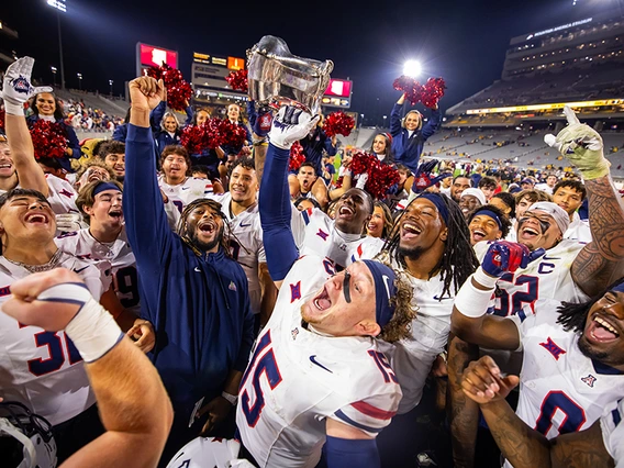 Several football players and cheerleaders celebrating