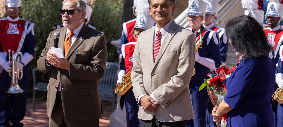 ron marx, suresh garimella and his wife lakshmi stand in front of old main