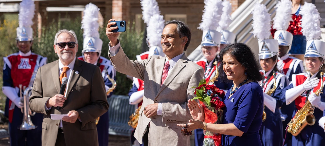 President Suresh Garimella takes a selfie with his wife, Lakshmi, in front of Old Main during an event welcoming him to campus.