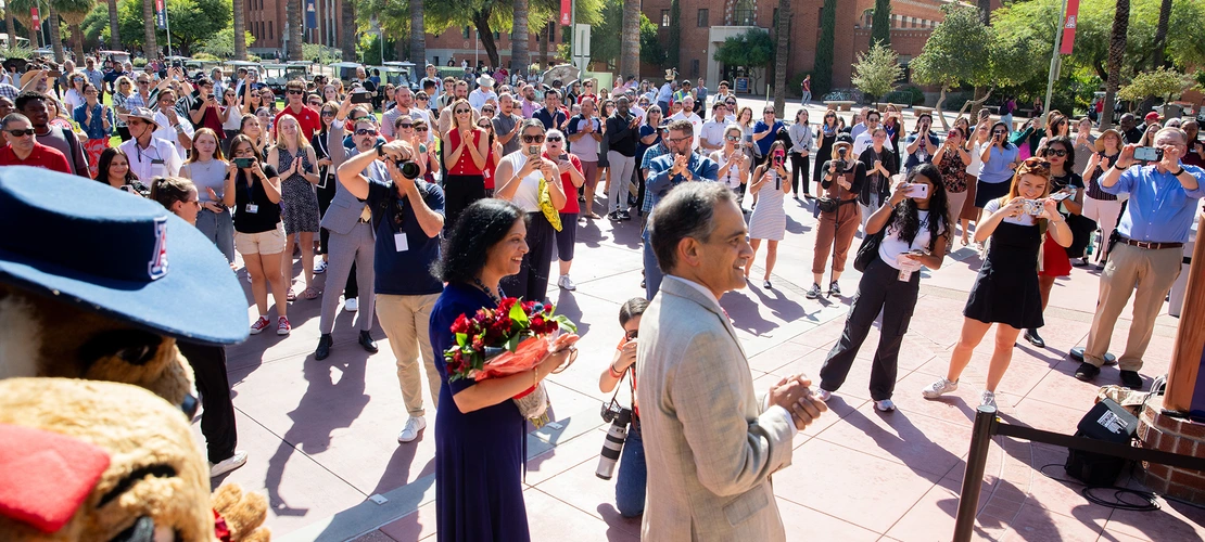 a crowd of people gather outside Old Main for an event to welcome President Suresh Garimella to campus