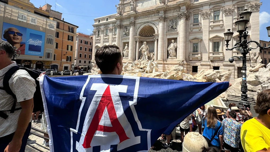 University of Arizona student holds flag with Block A