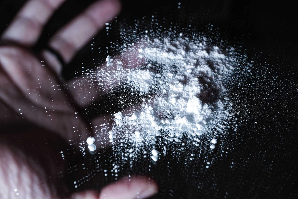 White opioid powder on glass