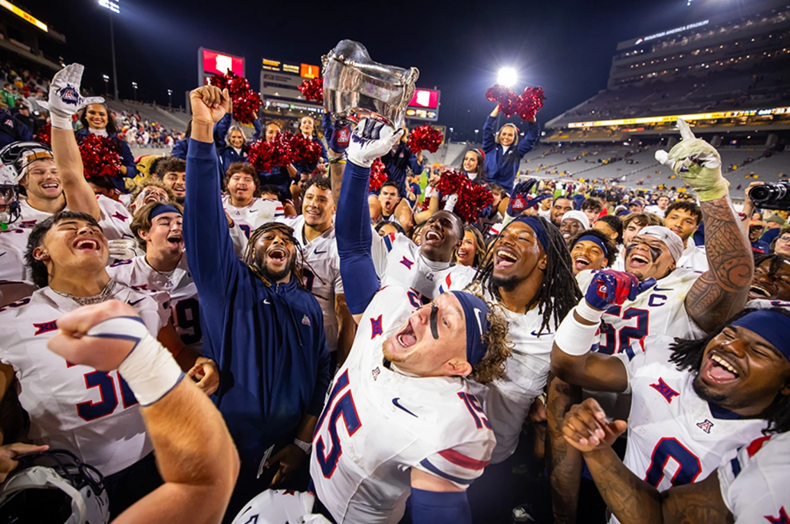 Several football players and cheerleaders celebrating