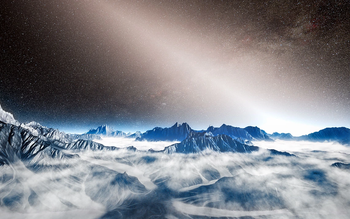 Exozodiacal dust is depicted as a white, glowing haze above the mountainous horizon of a hypothetical exoplanet in this artist's depiction. 