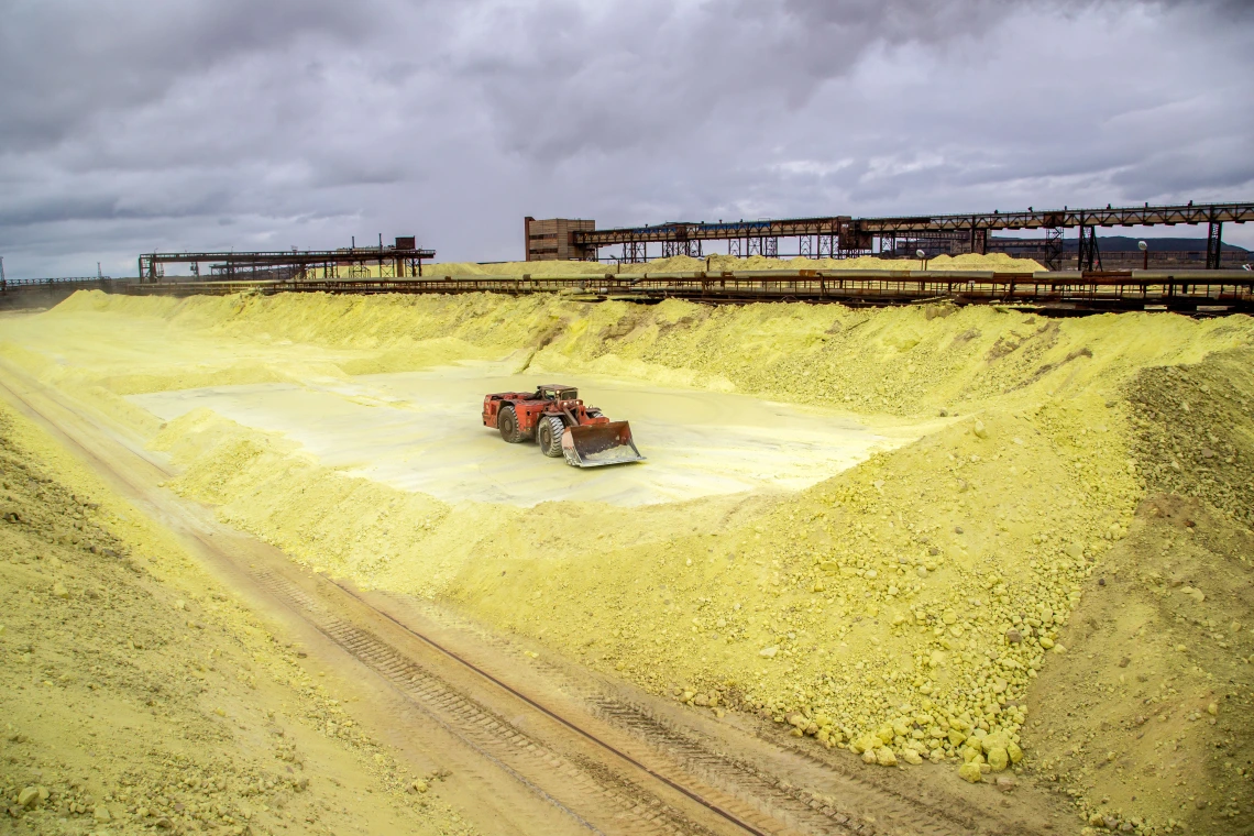 A tractor in a sea of yellow powder (sulfur)