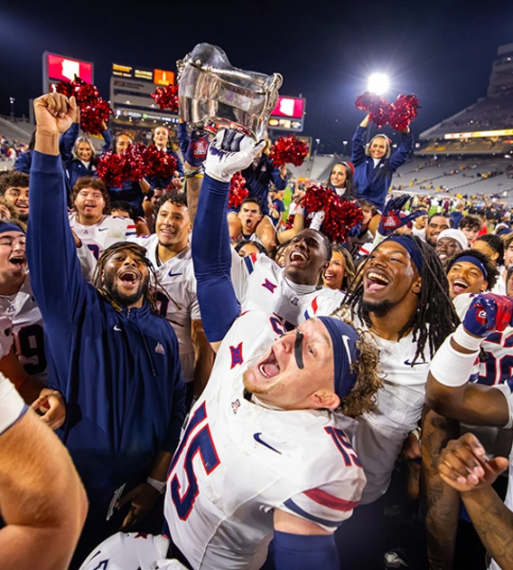 Several football players and cheerleaders celebrating