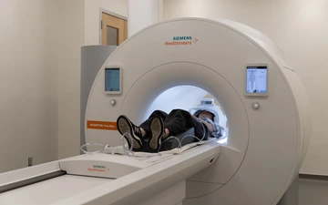 MRI machine scans patient