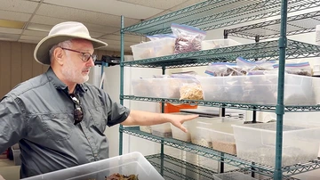 A professor shows a variety of plant material.