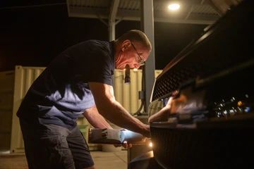 Bill Mason replaces a headlight bulb