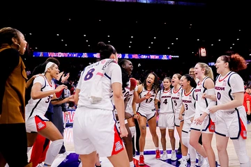 Women's basketball players in a huddle